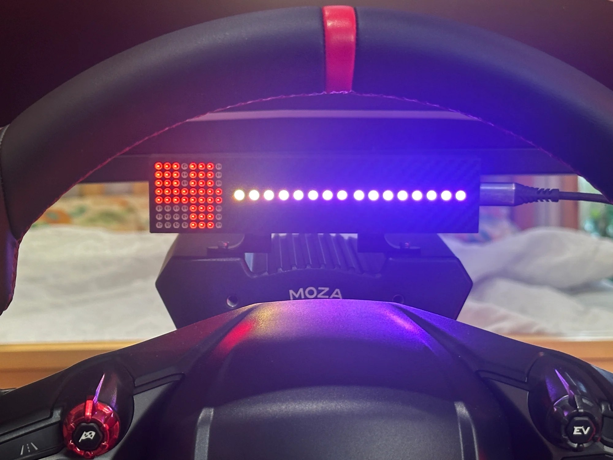 The 16-LED shift bar lit across its full width on the MOZA-mounted unit