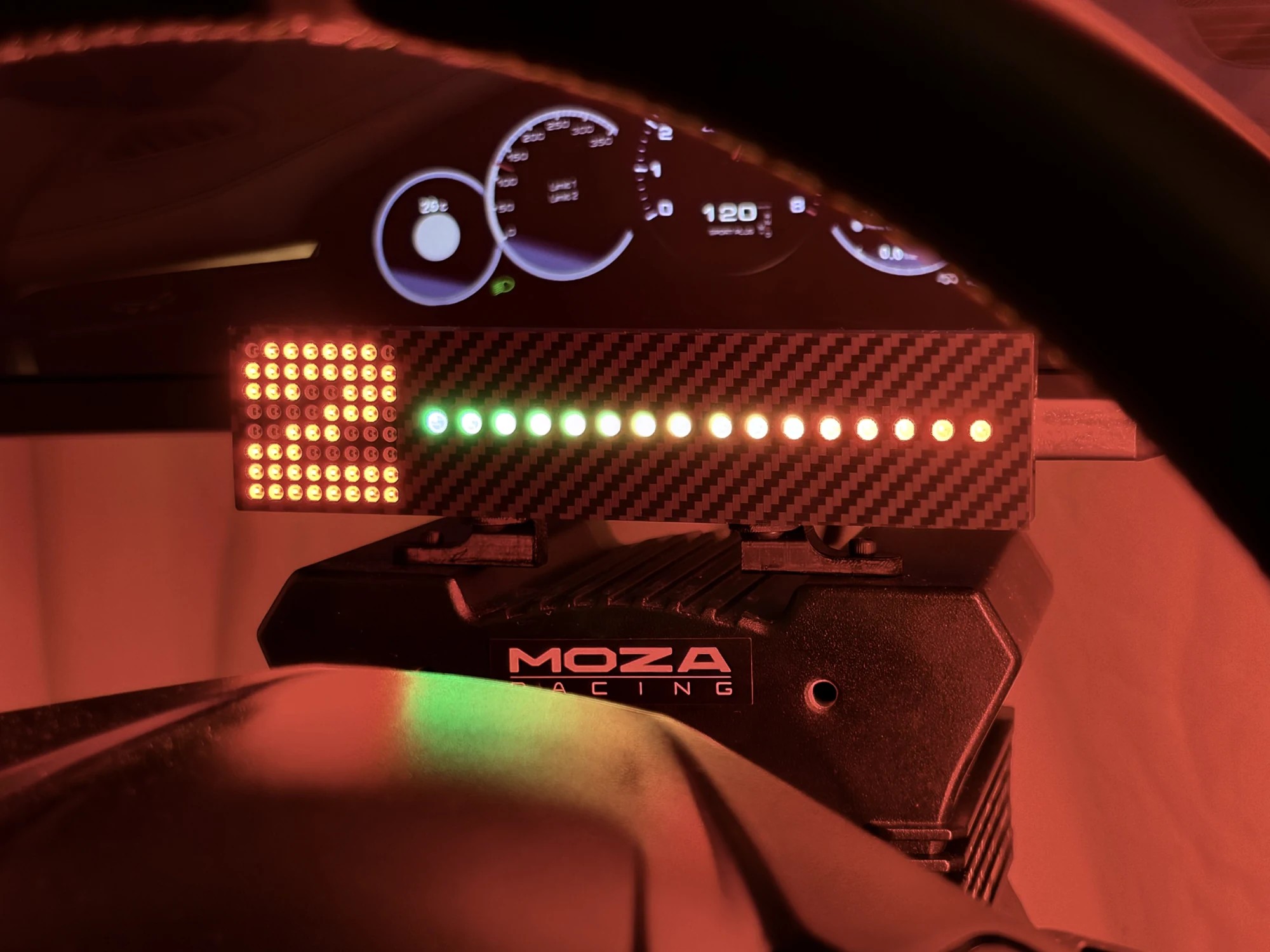The unit on a MOZA wheelbase with the shift bar running green, amber and red across its full width and the gear matrix showing second